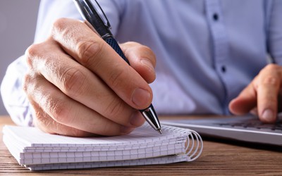 Person writing testimonial